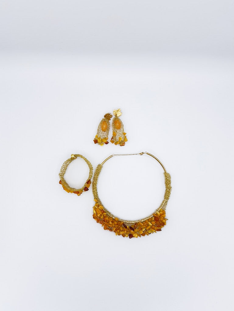 Collar, pendientes y brazalete en acero dorado y ámbar